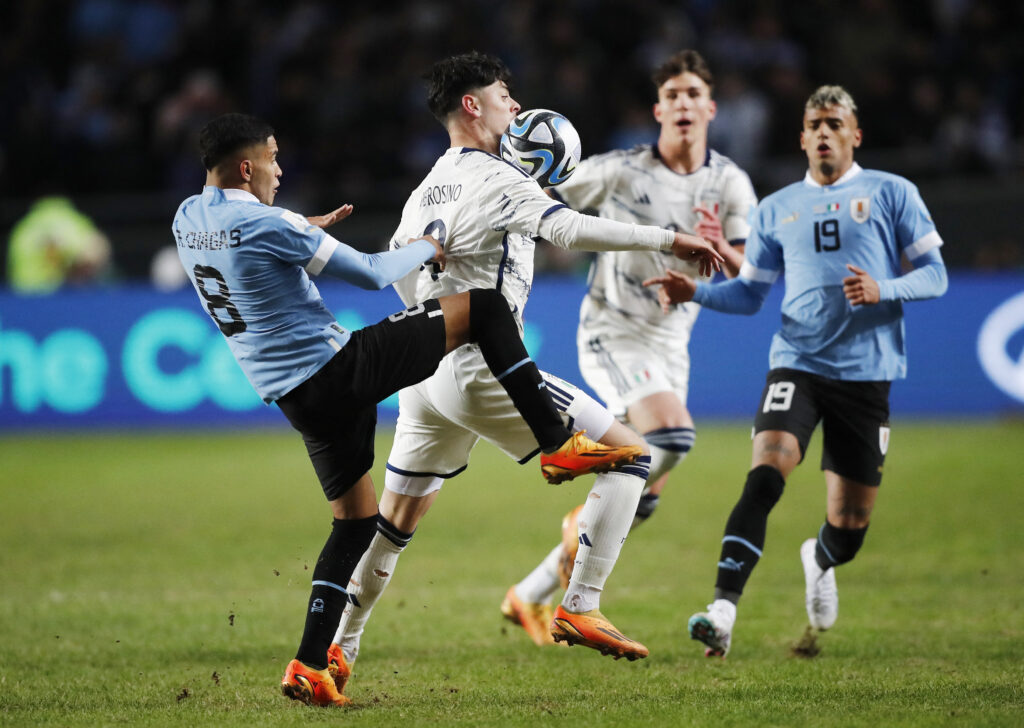 Uruguay's Rodrigo Chagas in action with Italy's Giuseppe Ambrosino in U20 World Cup