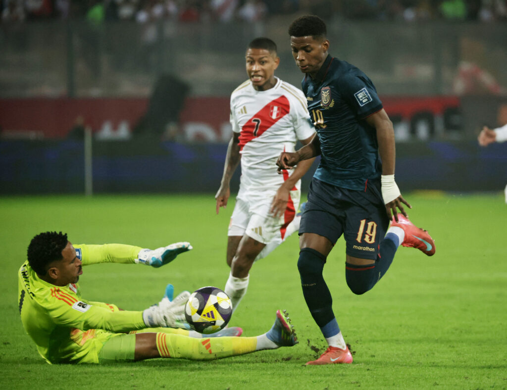 Ecuador's Nilson Angulo in action with Peru's Pedro Gallese