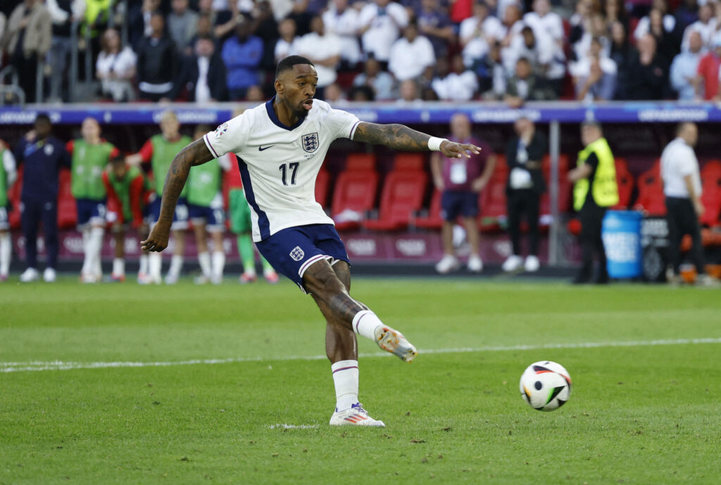 Ivan Toney kicks a penalty during an international match.